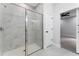 Walk-in shower with marble tile and glass enclosure at 405 N Mcdonald Ave, Deland, FL 32724