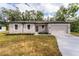 Newly built one-story house with a driveway and grassy lawn at 405 N Mcdonald Ave, Deland, FL 32724