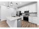 Modern kitchen with white shaker cabinets and granite island at 405 N Mcdonald Ave, Deland, FL 32724