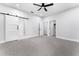 Primary bedroom with barn door, walk-in closet, and ceiling fan at 405 N Mcdonald Ave, Deland, FL 32724