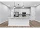Modern kitchen with white cabinets, granite counters, and island at 405 N Mcdonald Ave, Deland, FL 32724