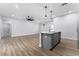 Open kitchen with island, stainless steel appliances, and granite counters at 405 N Mcdonald Ave, Deland, FL 32724