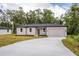 Tan house with black trim and driveway at 405 N Mcdonald Ave, Deland, FL 32724