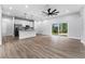 Open concept living area, featuring kitchen, island, and hardwood floors at 405 N Mcdonald Ave, Deland, FL 32724