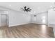 Open floor plan with hardwood floors and access to hallway at 405 N Mcdonald Ave, Deland, FL 32724