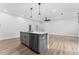 Modern kitchen island with granite countertop and stainless steel appliances at 405 N Mcdonald Ave, Deland, FL 32724