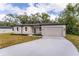 Tan house with black trim and driveway at 405 N Mcdonald Ave, Deland, FL 32724