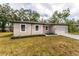 Tan house with black trim and driveway at 405 N Mcdonald Ave, Deland, FL 32724