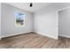 Bright bedroom with wood-look flooring and neutral walls at 405 N Mcdonald Ave, Deland, FL 32724