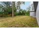 Large backyard with grassy area and mature trees at 405 N Mcdonald Ave, Deland, FL 32724