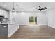 Open living space with kitchen island and sliding glass doors at 405 N Mcdonald Ave, Deland, FL 32724