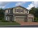 Two-story house with stone accents and two car garage at 5274 Teirgarten St, St Cloud, FL 34771