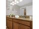 Double vanity bathroom with granite countertop and wood cabinets at 2955 Banana Palm Dr, Kissimmee, FL 34747