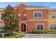 Townhouse exterior featuring attractive landscaping at 2955 Banana Palm Dr, Kissimmee, FL 34747