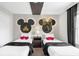 Two twin beds in a Mickey Mouse themed bedroom with a shared nightstand at 2955 Banana Palm Dr, Kissimmee, FL 34747