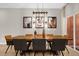 Elegant dining room with a large wooden table and modern lighting at 2955 Banana Palm Dr, Kissimmee, FL 34747