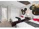 Two twin beds in a Mickey Mouse themed bedroom with a shared nightstand at 2955 Banana Palm Dr, Kissimmee, FL 34747