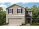 Two story home with neutral siding and two car garage at 4525 Ranunculus St, Lake Hamilton, FL 33851