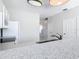 Kitchen with granite countertops, white cabinets, and a view of the hallway at 2338 Silver Palm Dr, Kissimmee, FL 34747