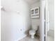 Small bathroom with toilet and a wall mounted cabinet at 2338 Silver Palm Dr, Kissimmee, FL 34747