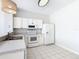 Modern kitchen with white cabinets, granite counters, and stainless steel appliances at 2338 Silver Palm Dr, Kissimmee, FL 34747
