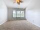 Main bedroom with neutral carpet and three windows at 2338 Silver Palm Dr, Kissimmee, FL 34747