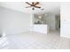 Open kitchen with white cabinets and breakfast bar at 2338 Silver Palm Dr, Kissimmee, FL 34747