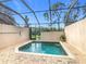 Private screened-in pool with brick pavers at 2338 Silver Palm Dr, Kissimmee, FL 34747