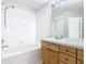Bathroom with a bathtub, shower, and wood cabinets at 2338 Silver Palm Dr, Kissimmee, FL 34747