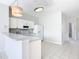 Modern kitchen with a breakfast bar, white cabinets, and granite countertops at 2338 Silver Palm Dr, Kissimmee, FL 34747
