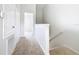 Upstairs hallway with carpet and access to bedrooms at 2338 Silver Palm Dr, Kissimmee, FL 34747