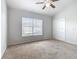 Spacious bedroom with neutral carpeting and large window at 2338 Silver Palm Dr, Kissimmee, FL 34747