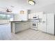 Modern kitchen with white cabinets, granite countertops, and stainless steel appliances at 2338 Silver Palm Dr, Kissimmee, FL 34747