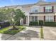 Townhouse exterior with landscaping and a red door at 2338 Silver Palm Dr, Kissimmee, FL 34747