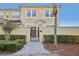 Two-story townhouse with red door and paved walkway at 2960 Bella Vista Dr, Davenport, FL 33897