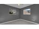 Bright bedroom with gray walls and two windows at 3417 Pershing Ave, Orlando, FL 32812