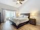 Bright bedroom with sliding glass doors leading to a patio and a king-size bed at 693 Charrice Pl, Sanford, FL 32771