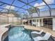 Relaxing screened pool area with patio furniture and outdoor kitchen at 693 Charrice Pl, Sanford, FL 32771