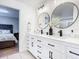 Double vanity bathroom with modern fixtures and circular mirrors at 693 Charrice Pl, Sanford, FL 32771