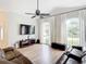 Spacious living room with hardwood floors, large TV, and comfortable seating at 693 Charrice Pl, Sanford, FL 32771