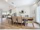 Bright dining room with hardwood floors and a large wooden table at 693 Charrice Pl, Sanford, FL 32771