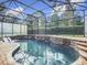 Inviting screened pool with a spacious patio and lounge chairs at 693 Charrice Pl, Sanford, FL 32771