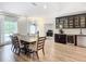 Modern dining room with hardwood floors, built-in bar, and open concept at 693 Charrice Pl, Sanford, FL 32771