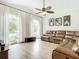 Relaxing living room with vaulted ceilings, hardwood floors, and large windows at 693 Charrice Pl, Sanford, FL 32771