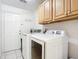 Convenient laundry room with washer, dryer, and cabinets at 693 Charrice Pl, Sanford, FL 32771