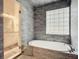 Elegant bathroom featuring a free-standing oval bathtub and gray tile at 693 Charrice Pl, Sanford, FL 32771