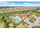 Aerial view of community pool, clubhouse, and parking lot at 955 Braewood Dr, Clermont, FL 34715