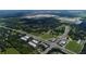 Aerial view of homes, roads, and businesses near a lake at 5310 Teirgarten St, Saint Cloud, FL 34771