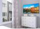 Bedroom featuring a dresser, TV, and city view at 7740 Sandy Ridge Dr # 218, Reunion, FL 34747