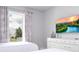 Bedroom with two twin beds and a large TV at 7740 Sandy Ridge Dr # 218, Reunion, FL 34747